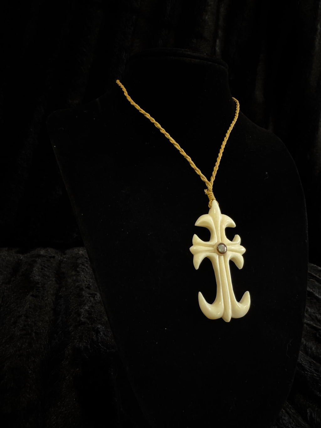 Cross design pendant on cord necklace