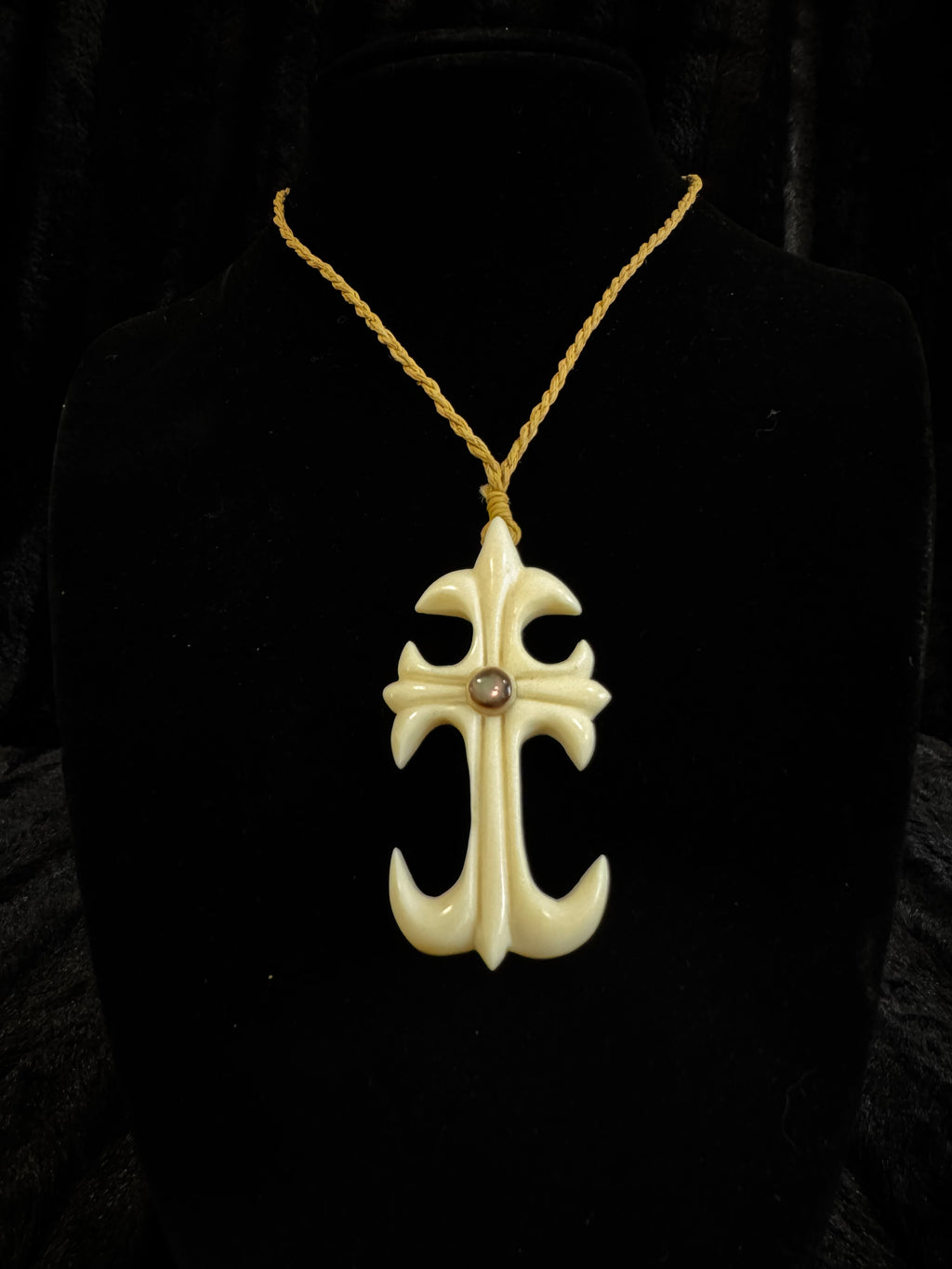 Cross design pendant on cord necklace