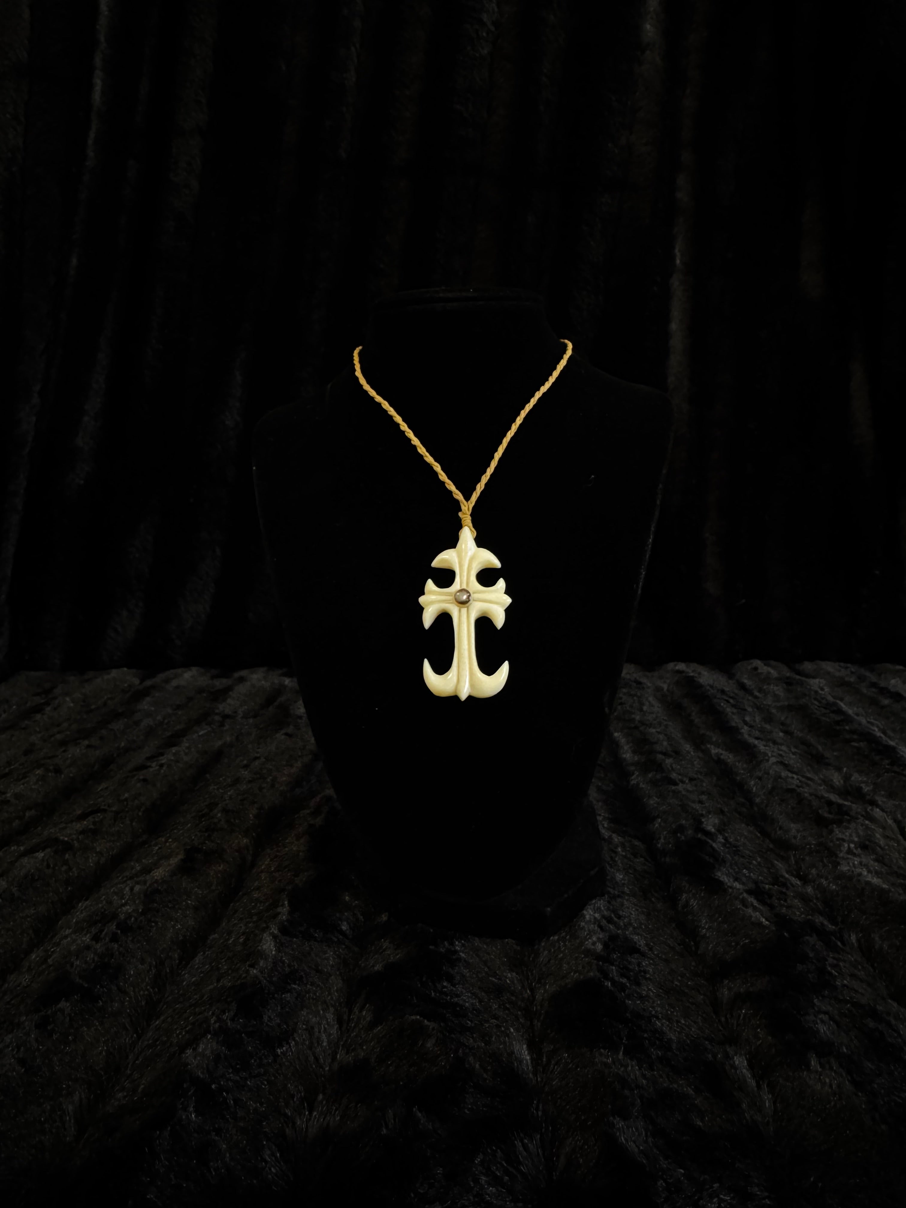 Cross design pendant on cord necklace