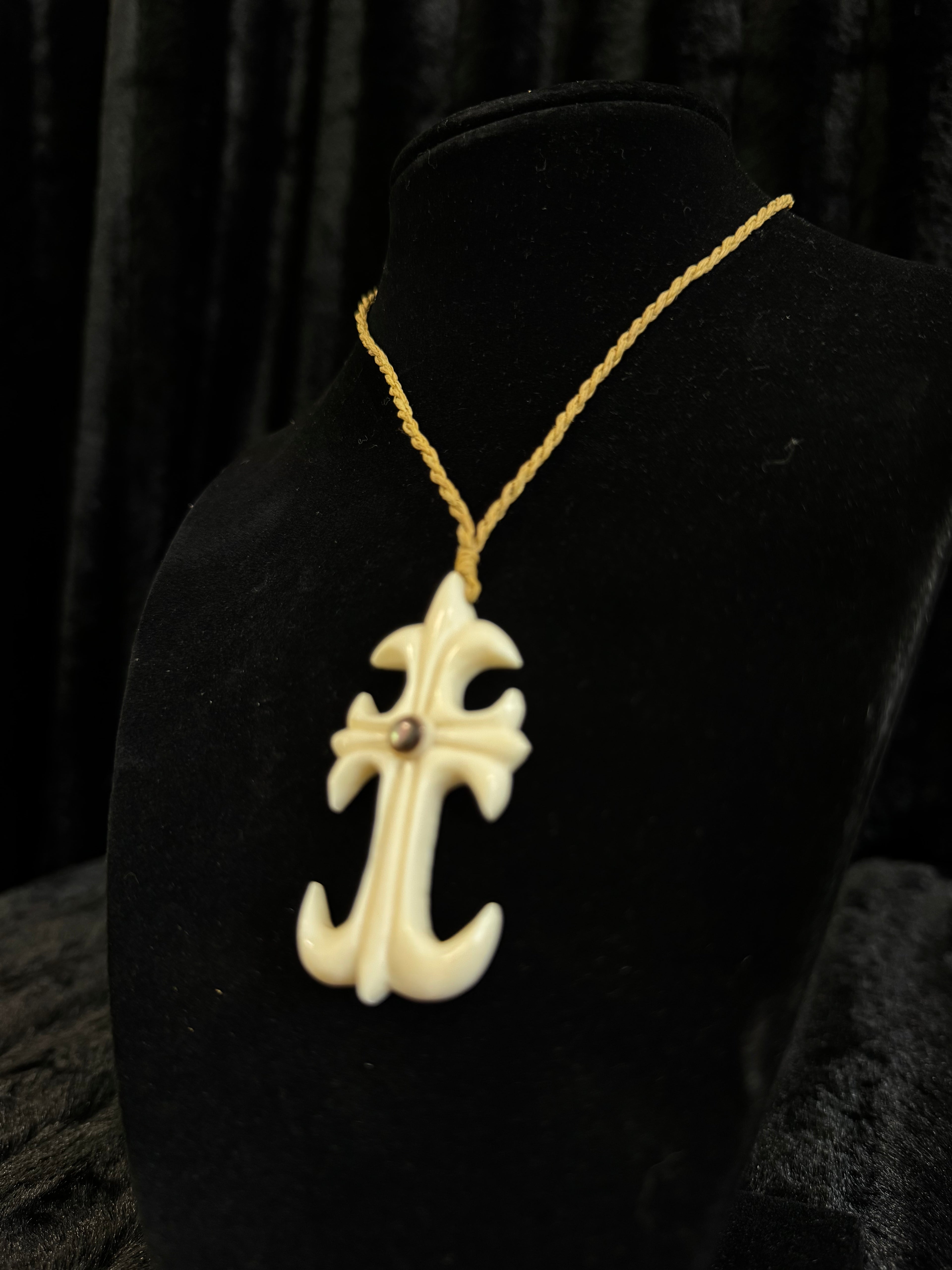 Cross design pendant on cord necklace